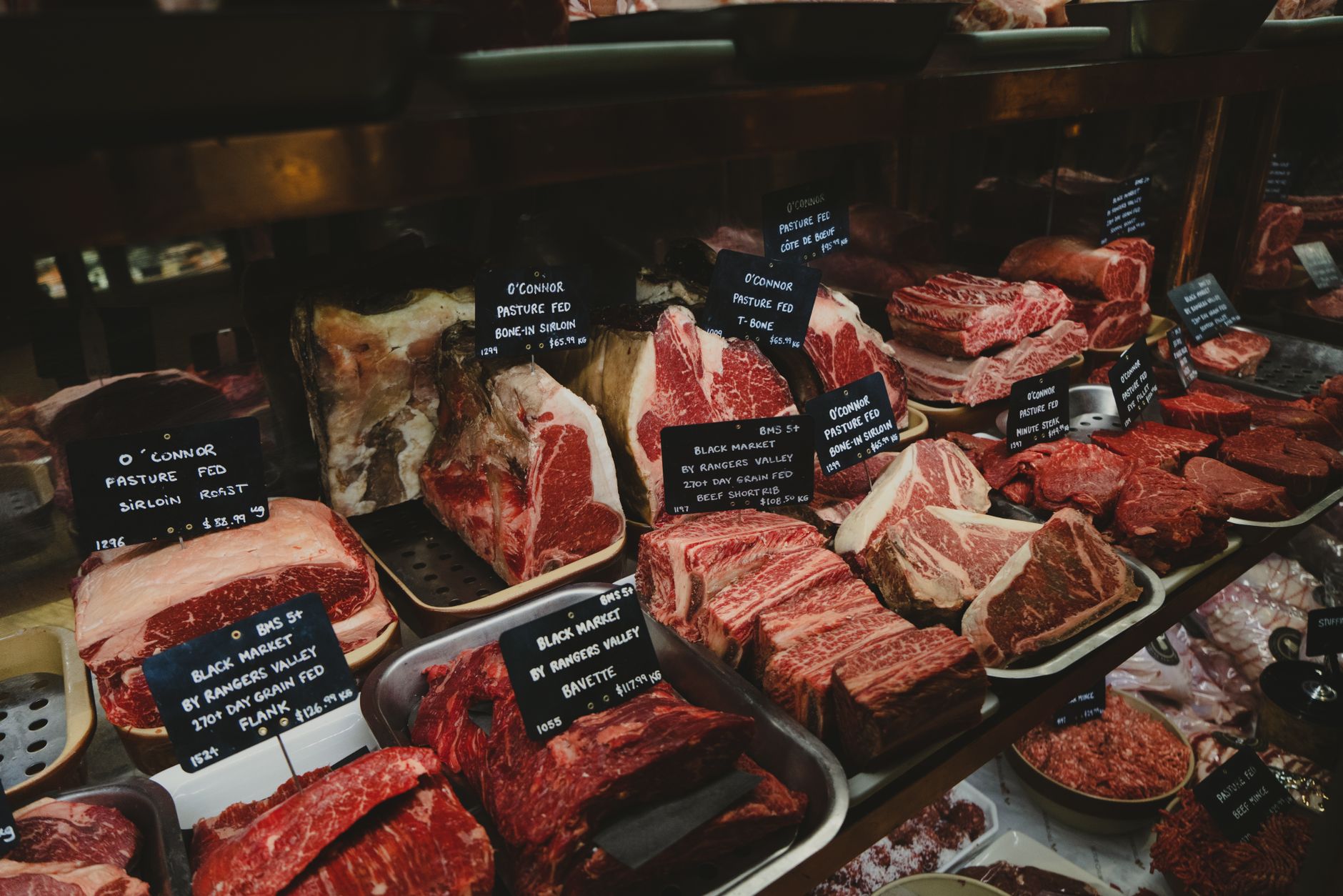 A butcher's display cabinet with cuts of meat laid out