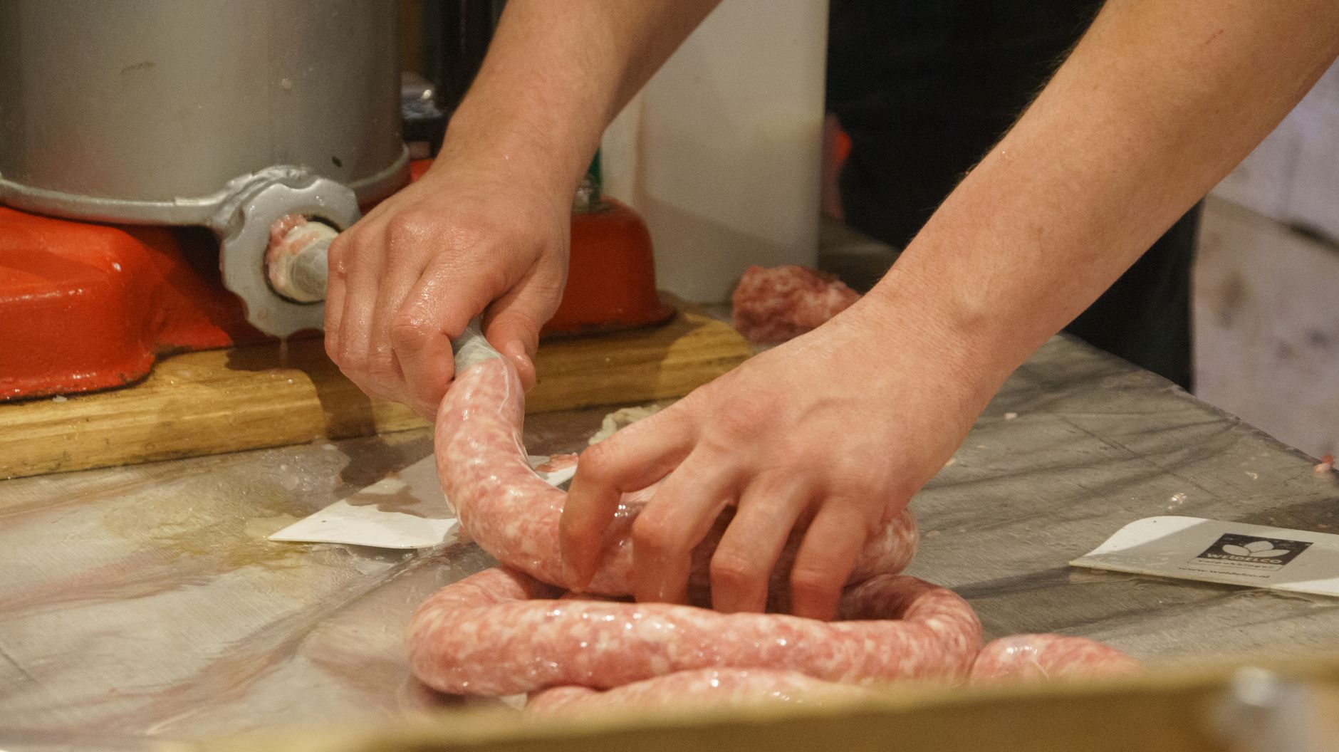 Fresh sausages coiled on a tray
